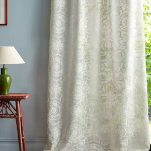 green botanical curtain with side table and lamps