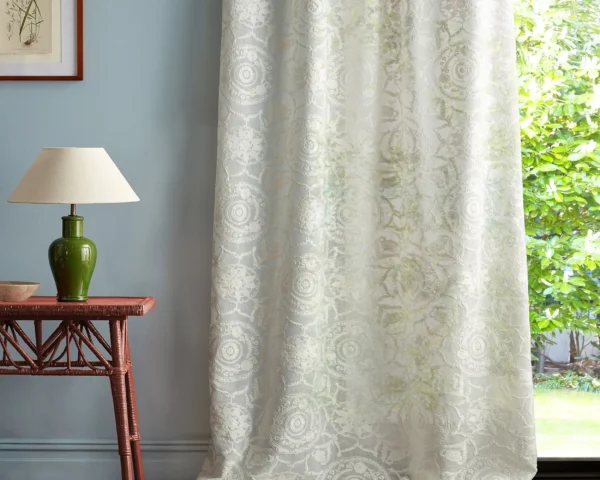 green botanical curtain with side table and lamps