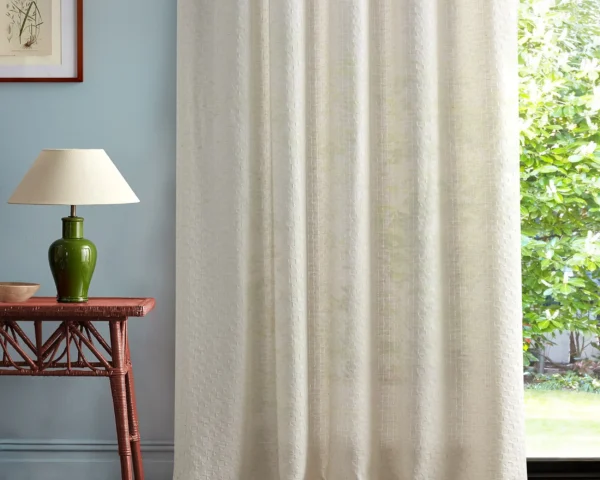 white geometric curtain with side table and lamps