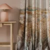 orange botanical curtain with side table and lamps