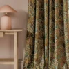 green botanical curtain with side table and lamps