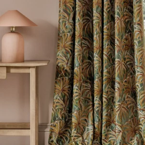 green botanical curtain with side table and lamps