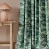 blue botanical curtain with side table and lamps