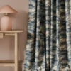 blue botanical curtain with side table and lamps