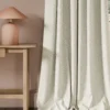 neutral botanical curtain with side table and lamps