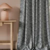 blue botanical curtain with side table and lamps
