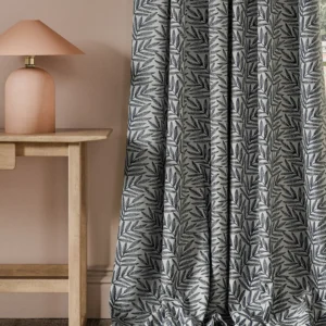 blue botanical curtain with side table and lamps