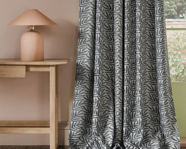 Virgata Fabric - Ink by blue botanical curtain with side table and lamps