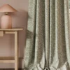 green botanical curtain with side table and lamps