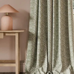 green botanical curtain with side table and lamps