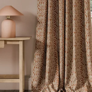 orange botanical curtain with side table and lamps