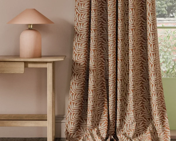 Virgata Fabric - Cinnamon by orange botanical curtain with side table and lamps