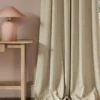 neutral striped curtain with side table and lamps