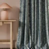blue striped curtain with side table and lamps