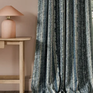 blue striped curtain with side table and lamps