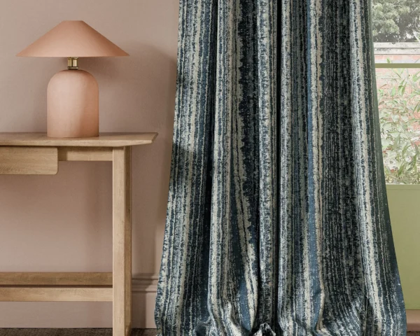 Striatus Fabric - Ink by blue striped curtain with side table and lamps