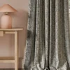 black-grey striped curtain with side table and lamps
