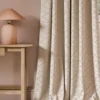 neutral contemporary curtain with side table and lamps