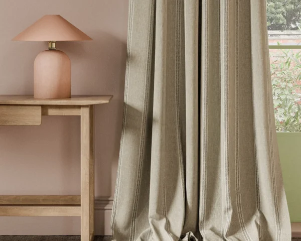 neutral striped curtain with side table and lamps