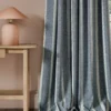 blue striped curtain with side table and lamps