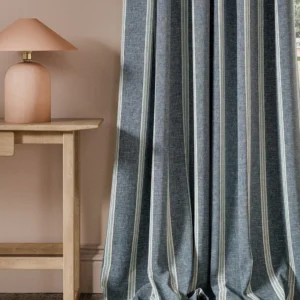 blue striped curtain with side table and lamps