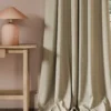 orange striped curtain with side table and lamps