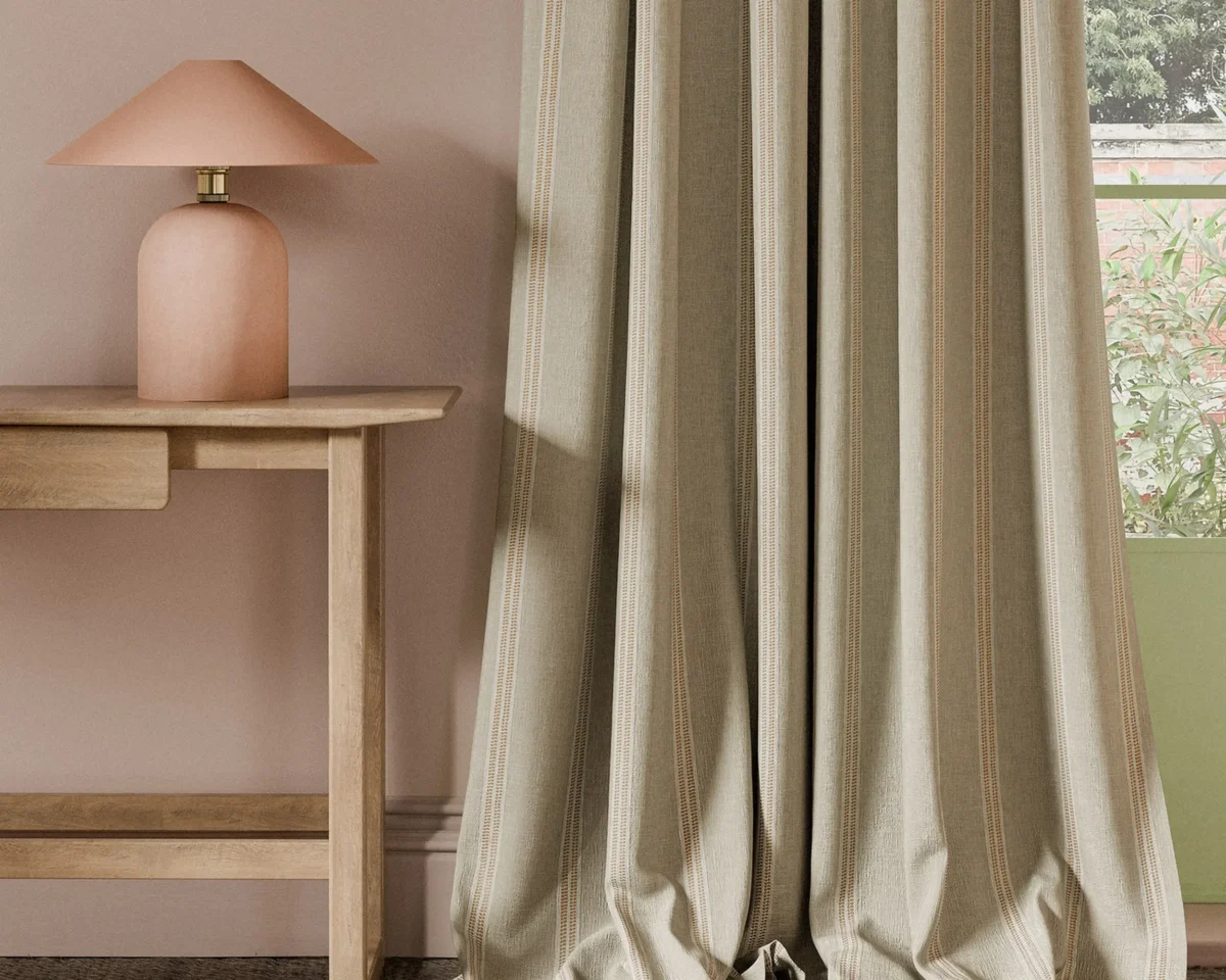 Ordo Fabric - Cinnamon by orange striped curtain with side table and lamps