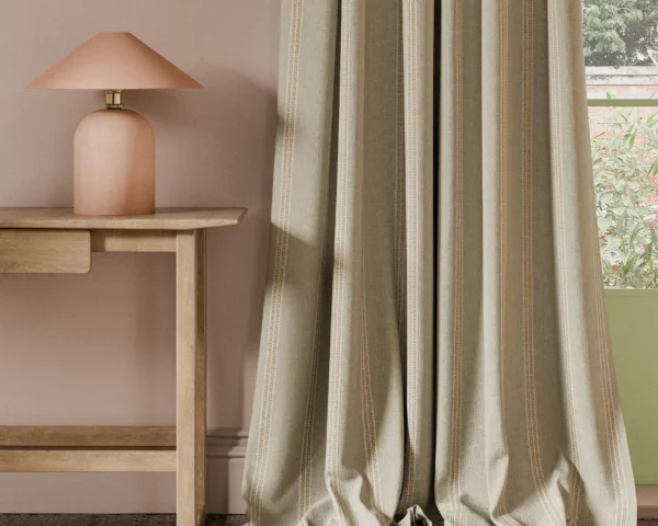 orange striped curtain with side table and lamps