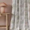neutral botanical curtain with side table and lamps