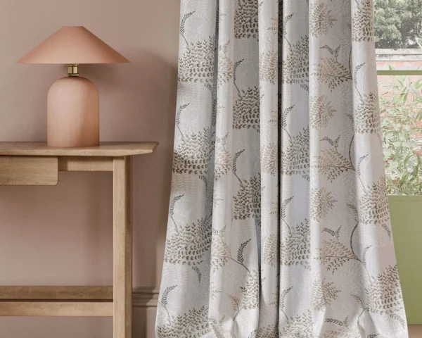 neutral botanical curtain with side table and lamps
