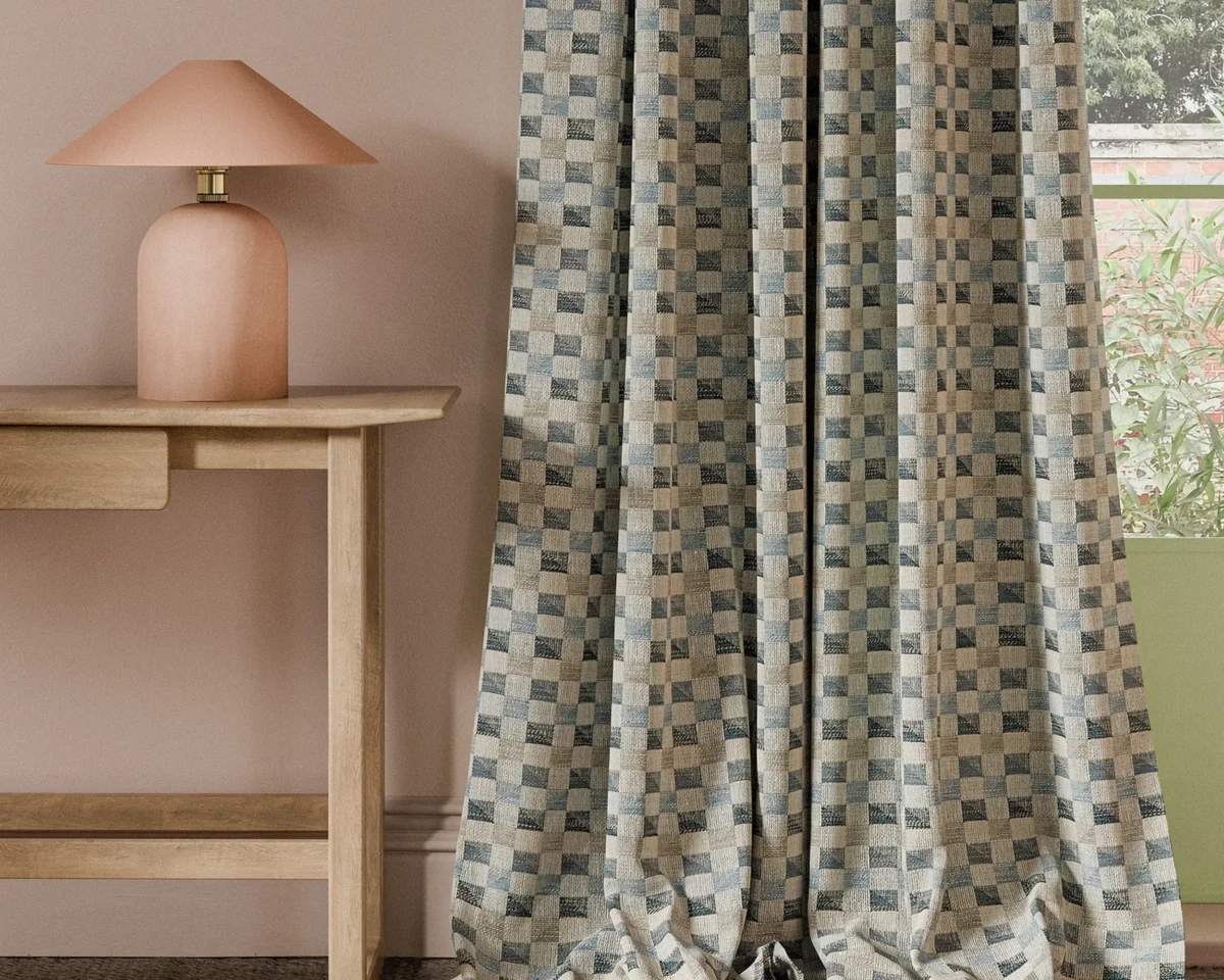 blue geometric curtain with side table and lamps
