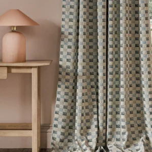 blue geometric curtain with side table and lamps