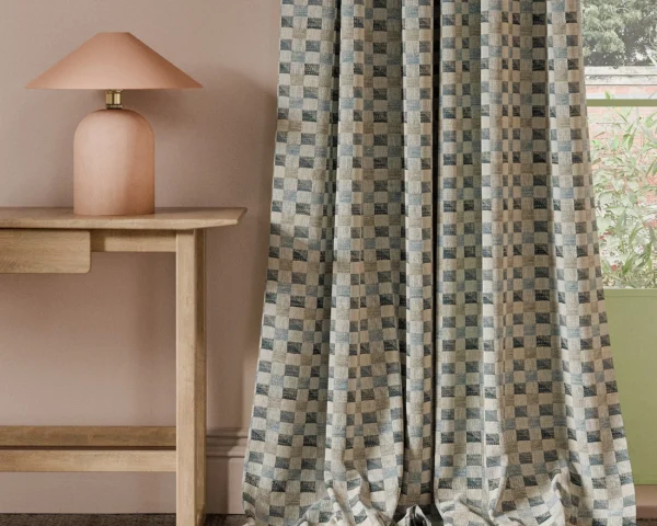 blue geometric curtain with side table and lamps