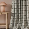 black-grey geometric curtain with side table and lamps