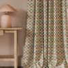 orange geometric curtain with side table and lamps