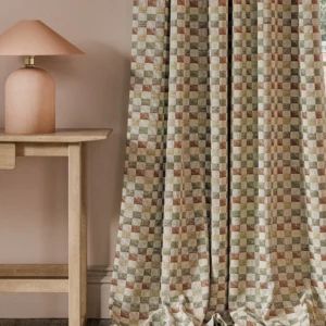 orange geometric curtain with side table and lamps