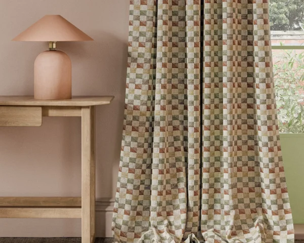 orange geometric curtain with side table and lamps