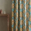 blue botanical curtain with side table and vases