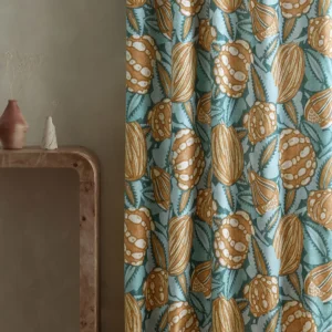 blue botanical curtain with side table and vases