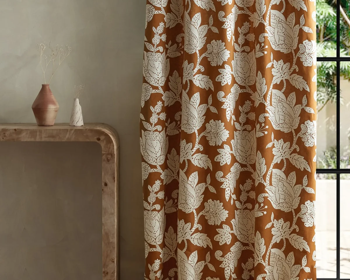 brown botanical curtain with side table and vases