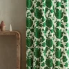 green botanical curtain with side table and vases