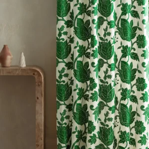 green botanical curtain with side table and vases