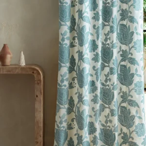 blue botanical curtain with side table and vases