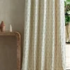 green striped curtain with side table and vases