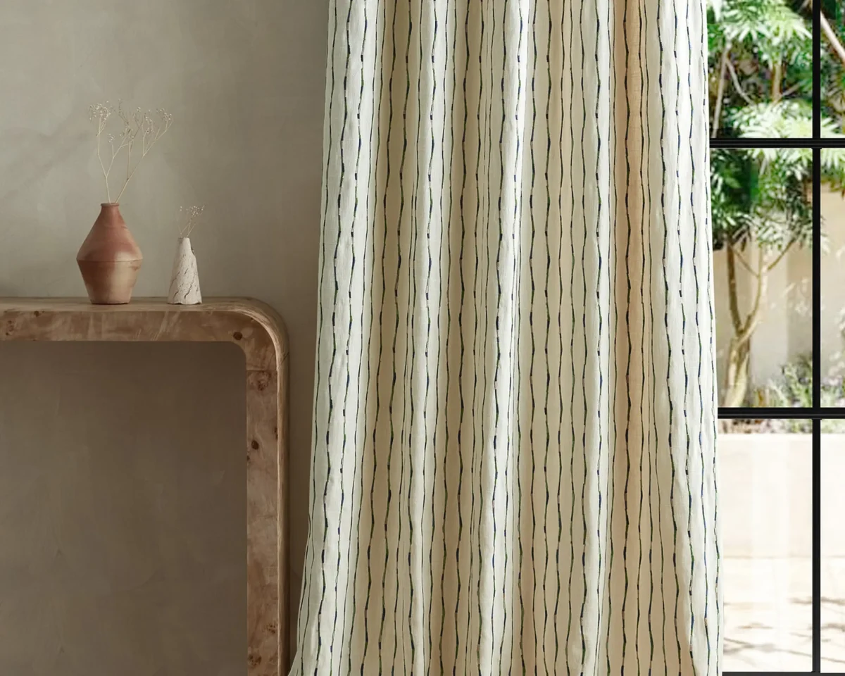 Morelia Fabric - Indigo / Malachite by green striped curtain with side table and vases