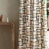 multicolour geometric curtain with side table and vases