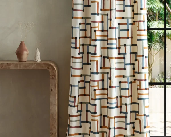 multicolour geometric curtain with side table and vases