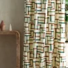 multicolour geometric curtain with side table and vases