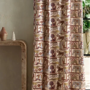 blue animal curtain with side table and vases