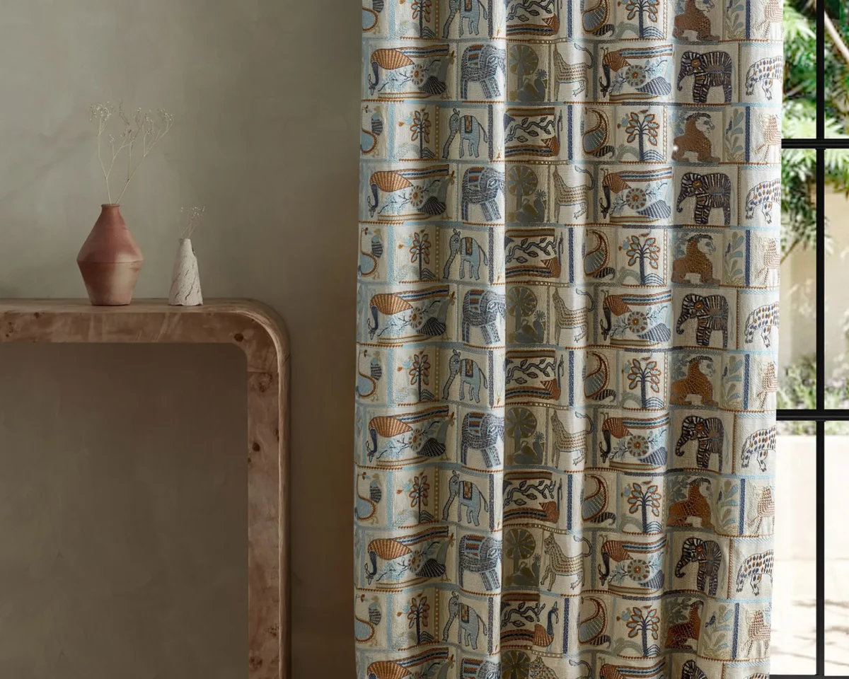 blue animal curtain with side table and vases